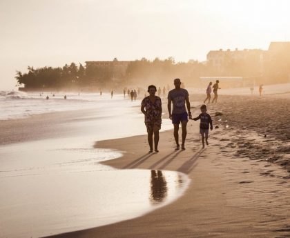 unknown persons walking on seashore