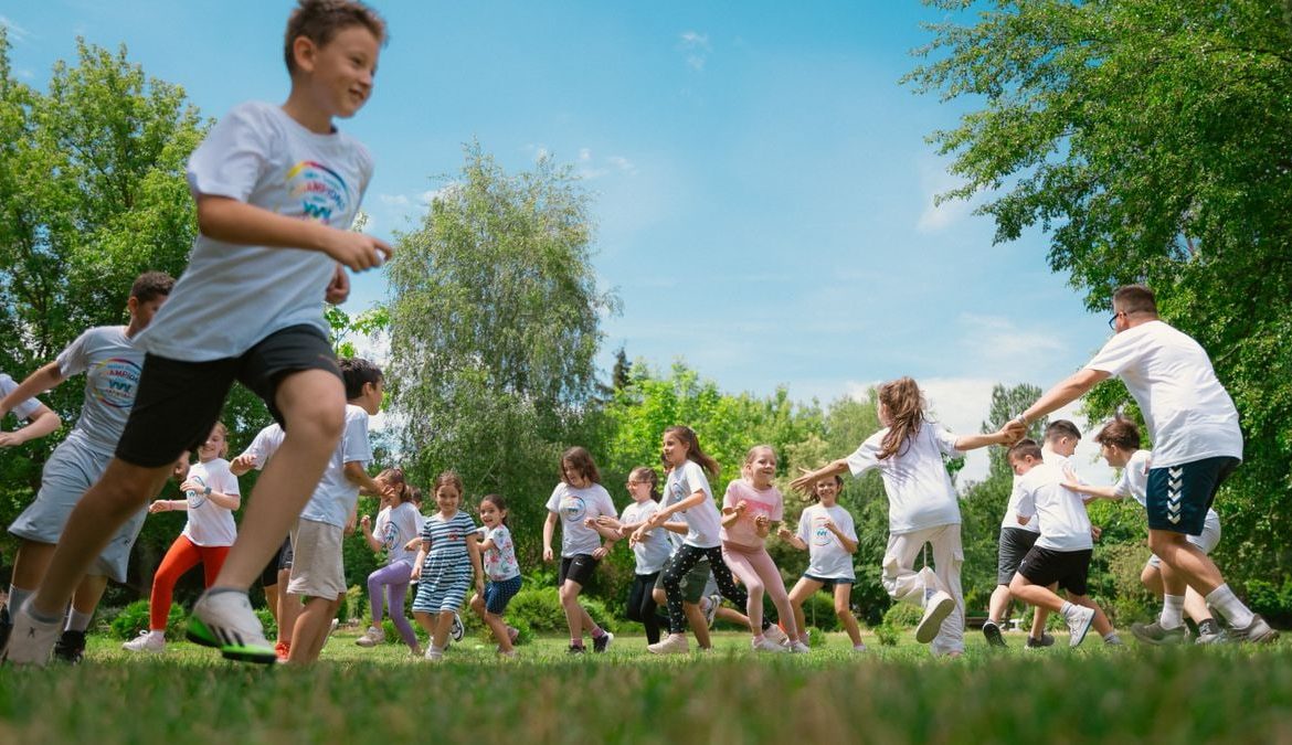 A group of children happily playing in a sunny park, enjoying outdoor activities and fun.